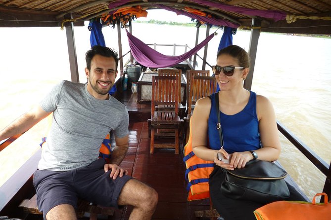 1-day Mekong Delta Tour: Cai Be Market, Local Island and Cycling - Big boat, small sampan, and quiet canals