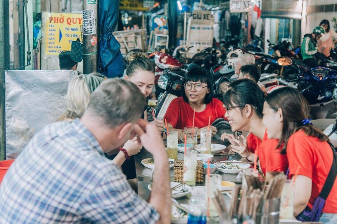 12 Tasting Street Food & Sightseeing By Scooter with Student - District 4 and the snack culture at Xom Chieu Market
