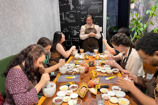 Bean to bar Chocolate Workshop in Ho Chi Minh City - Grinding Cacao Paste with a Granite Mortar