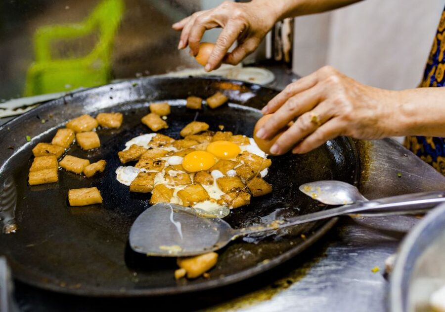 Ho Chi Minh City: Private Street Food Evening Walking Tour - Two classic street dishes in a local alley
