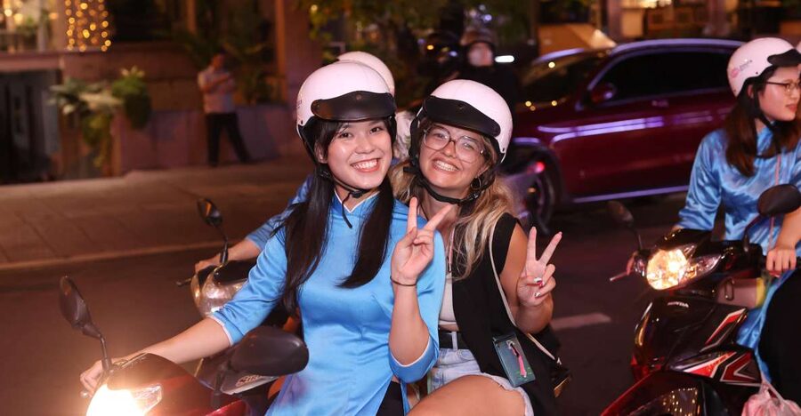 KISSTOUR| Saigon By Night & Street Food Tour on Motorbike - The Guides And The Ao Dai Detail
