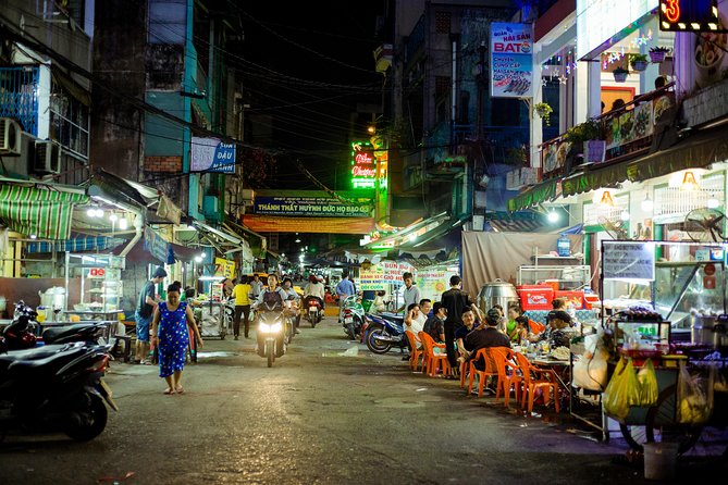 Private Vegan Food Tour By Scooter in Ho Chi Minh City - District 5 and District 4 show the city after dark
