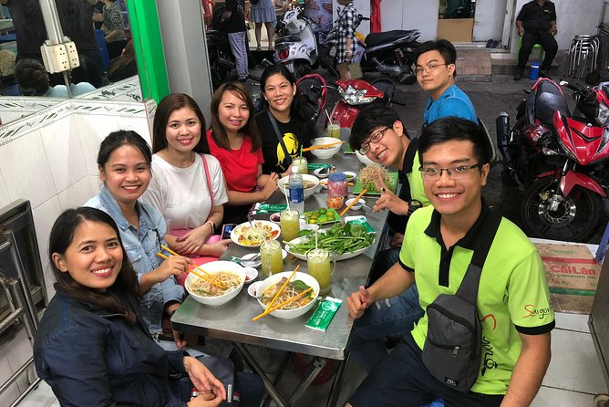 Saigon By Night and Street Food By Motorbike | Opt: Ao Dai Riders - Nguyen Trai Street, shops, and the city in motion