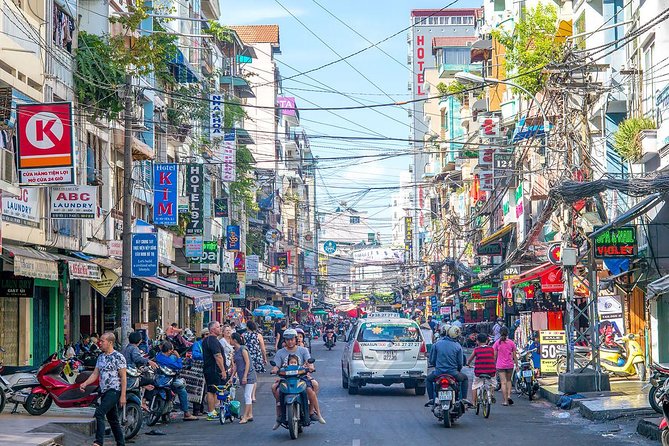 Small group Saigon Inside Out by Motorbike for 3 Hours - Markets, theater, food, and the city between stops